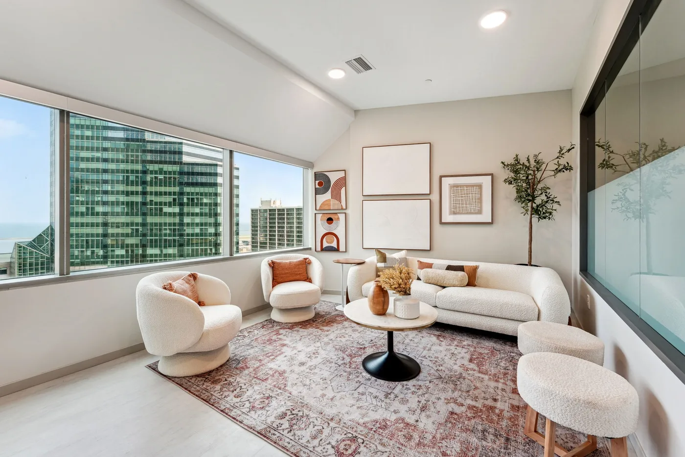 Bright sitting area at The Bell with large windows and downtown views