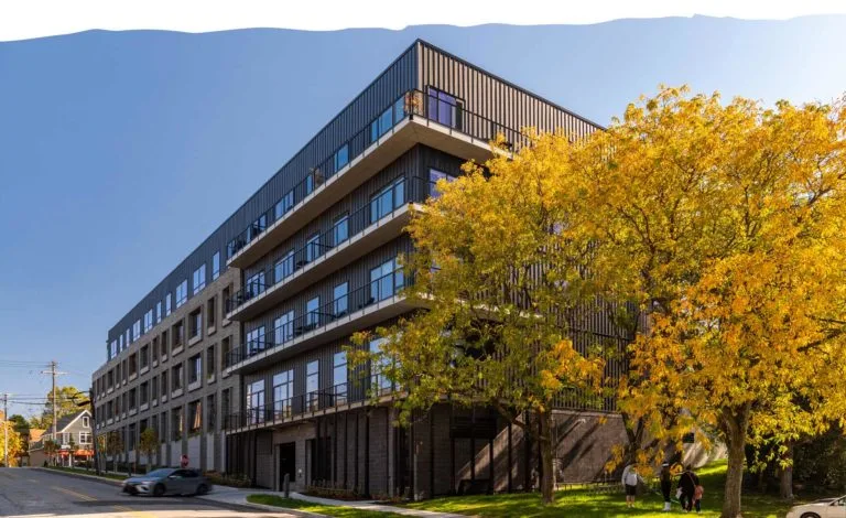 The Lincoln exterior with balconies and autumn trees