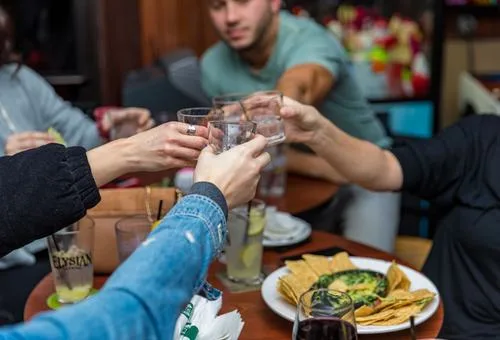 Guests sharing drinks at Happy Moose Bar and Grill