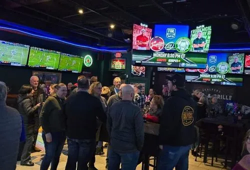 Game-day crowd and televisions at Scalpers Bar & Grille