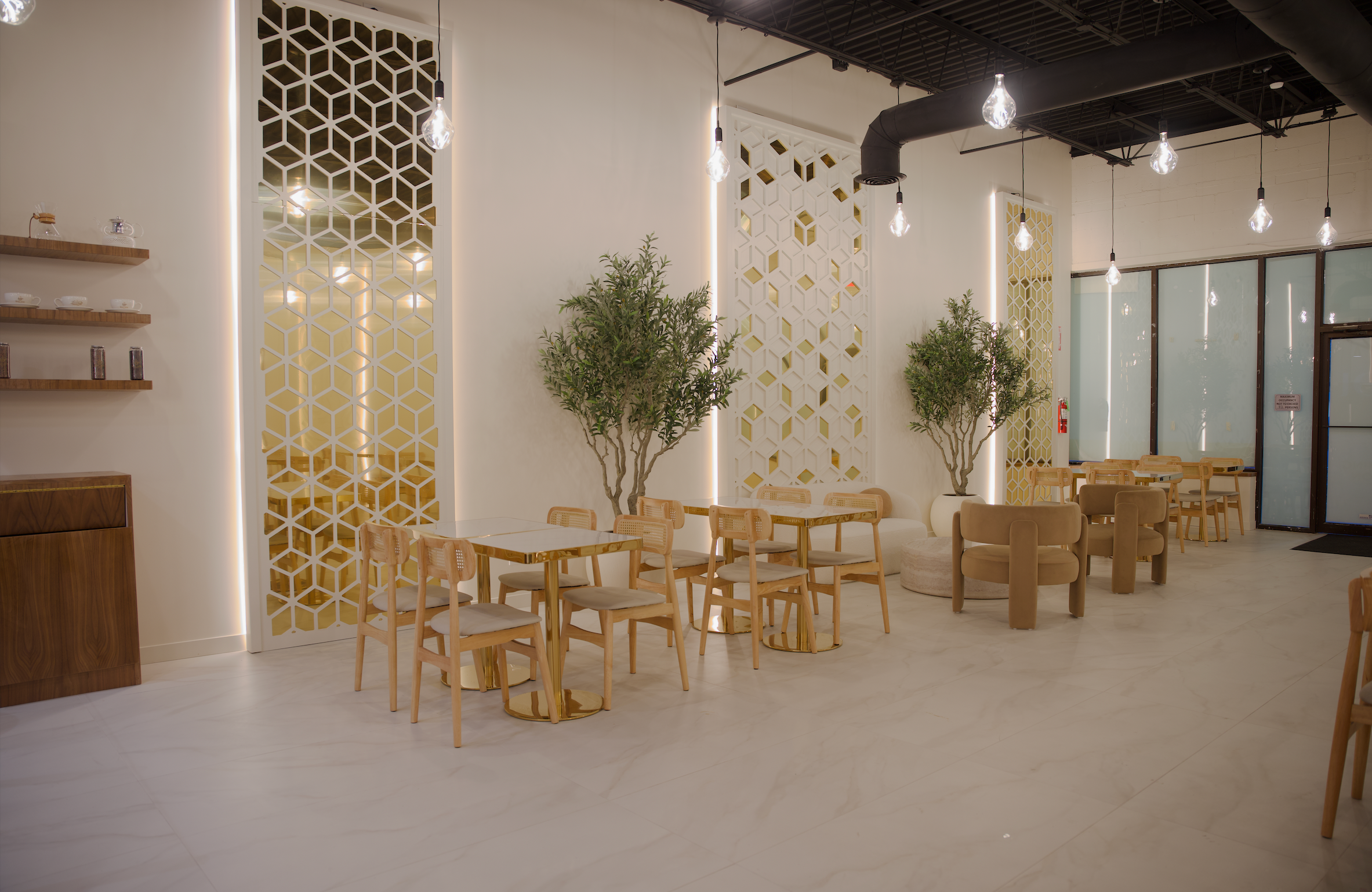 Baladi Coffee House interior with pale wood seating and decorative screens