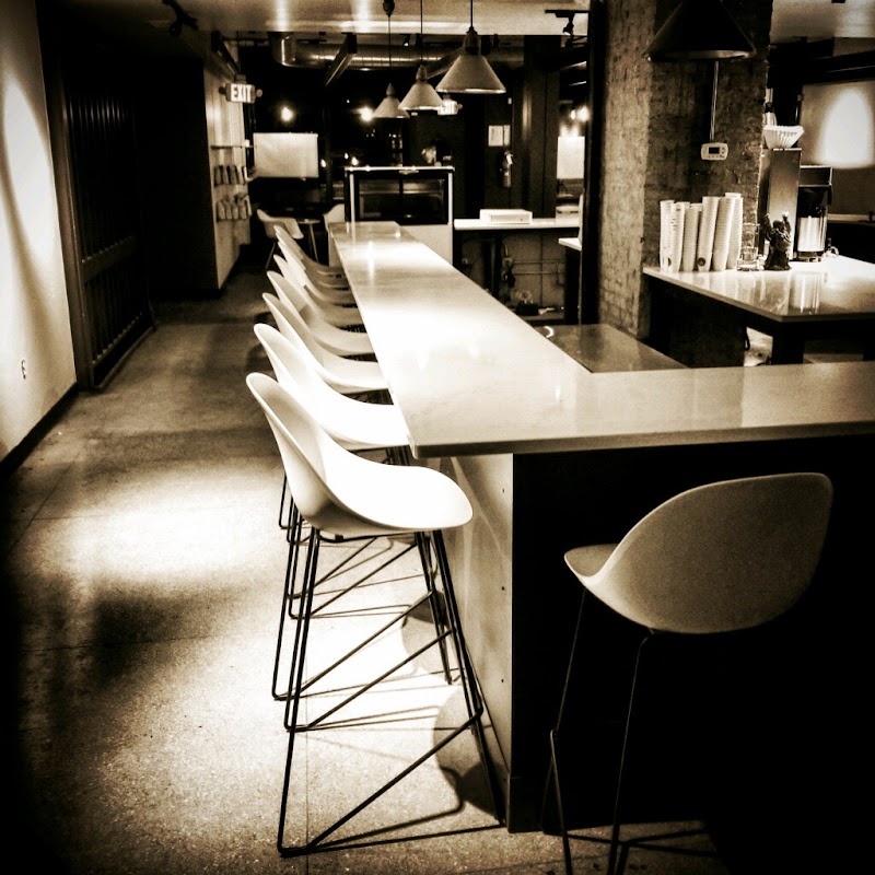 Long communal table and coffee counter at Blue Sky Brews