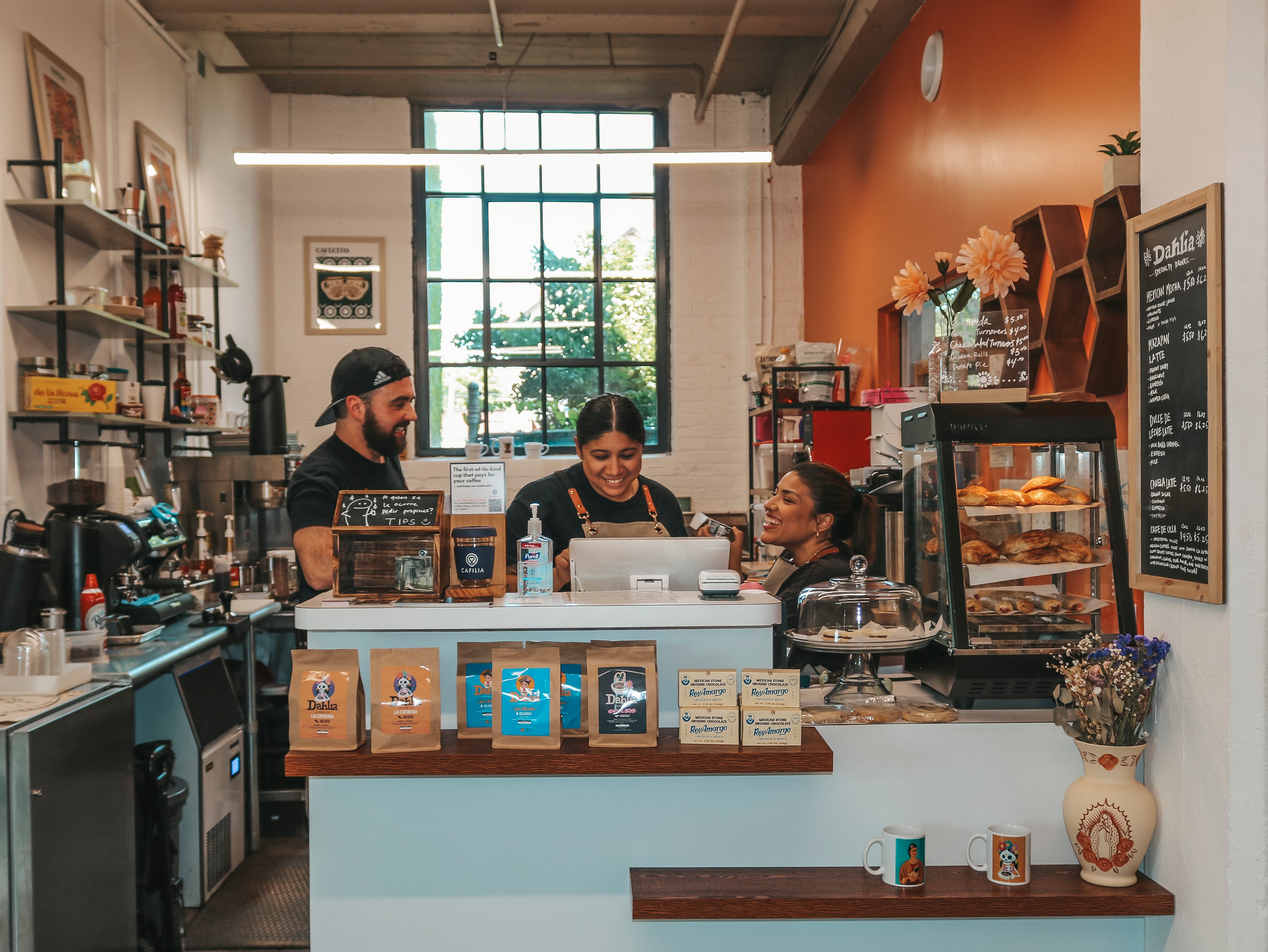 Colorful counter and baristas inside Dahlia Coffee Co