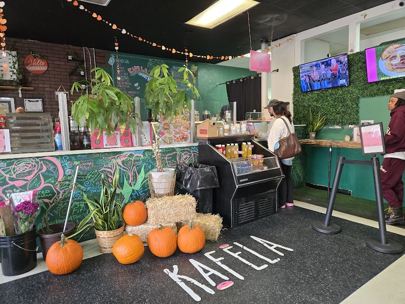 KafeLA counter with plants and colorful murals