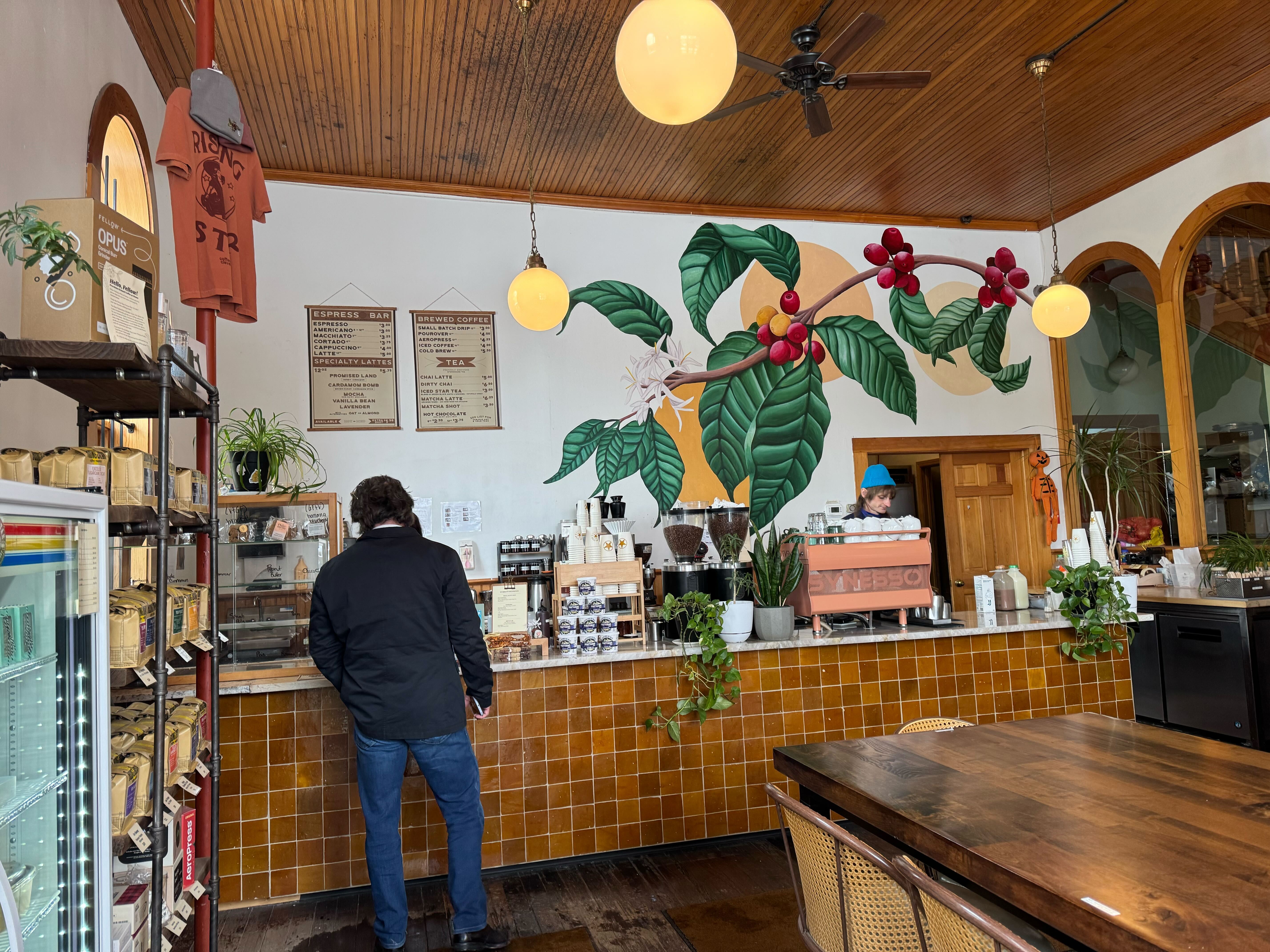 Coffee mural and counter inside Rising Star Coffee Roasters