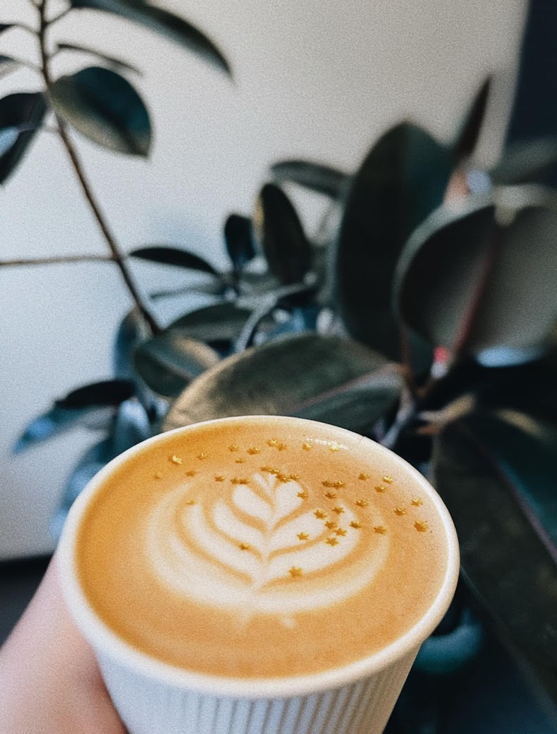 Latte art in a ceramic cup at The Grind Coffee Bar