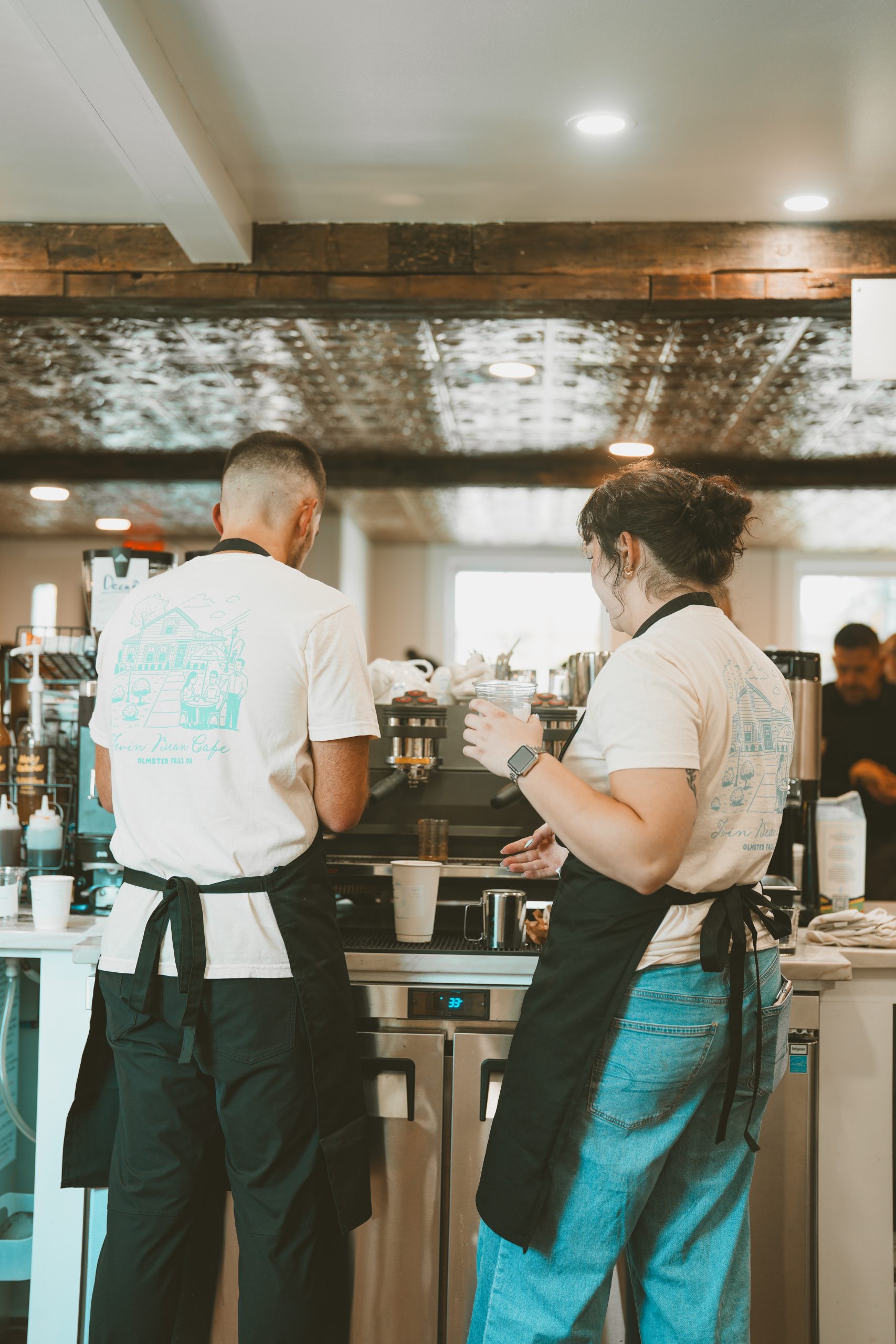 Baristas preparing drinks at the Twin Bean Cafe counter