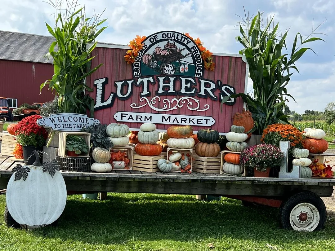 The farm market sign surrounded by pumpkins and fall decorations at Luther Farms in Richfield, Ohio