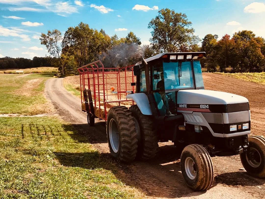 A tractor and hay wagon in the field at Rufener Hilltop Farms in Mogadore, Ohio