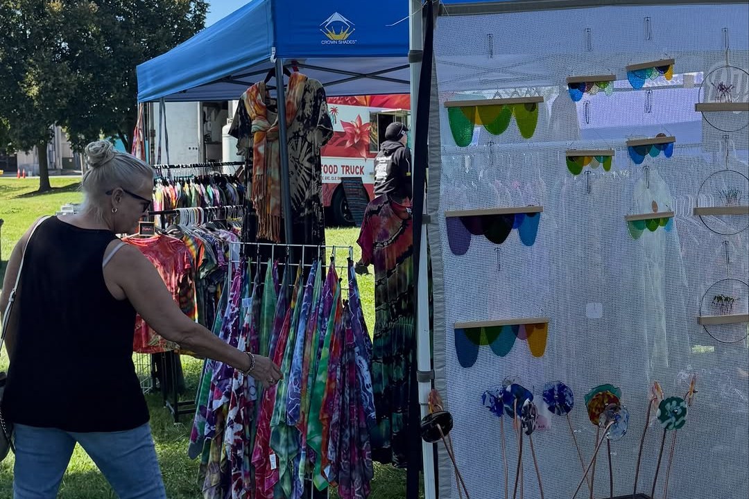 Shopper browsing vendor booths at the Akron Bazaar in Hardesty Park in Akron