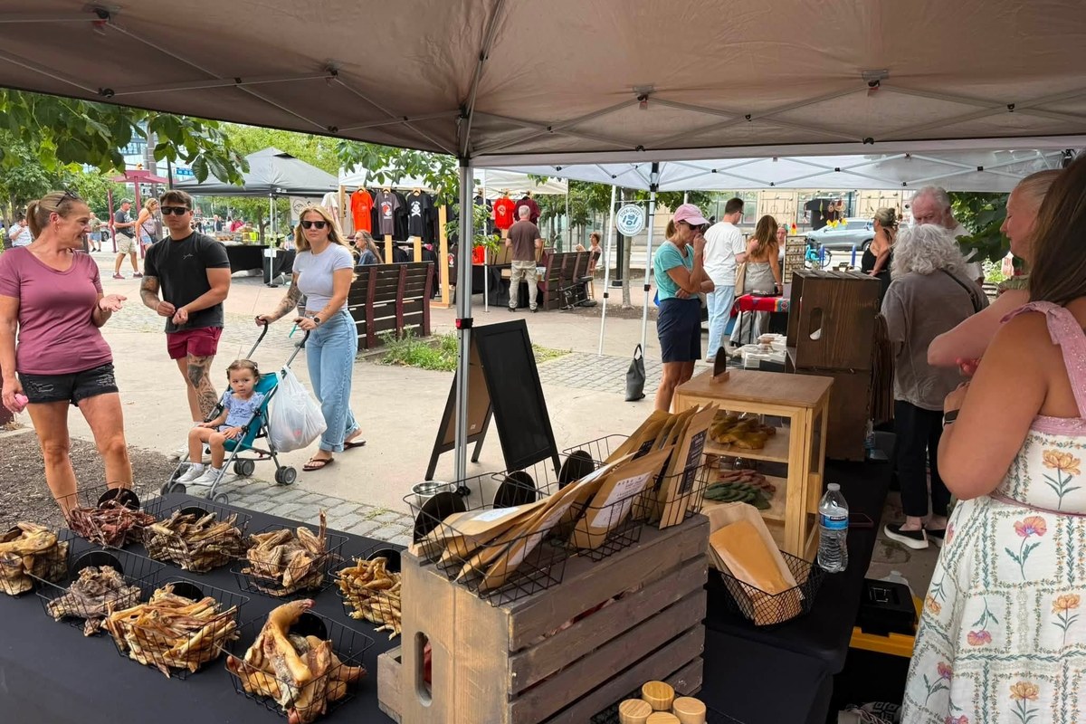 Shoppers browsing vendor tents at Cleveland Bazaar in Market Square Park in Ohio City, Cleveland