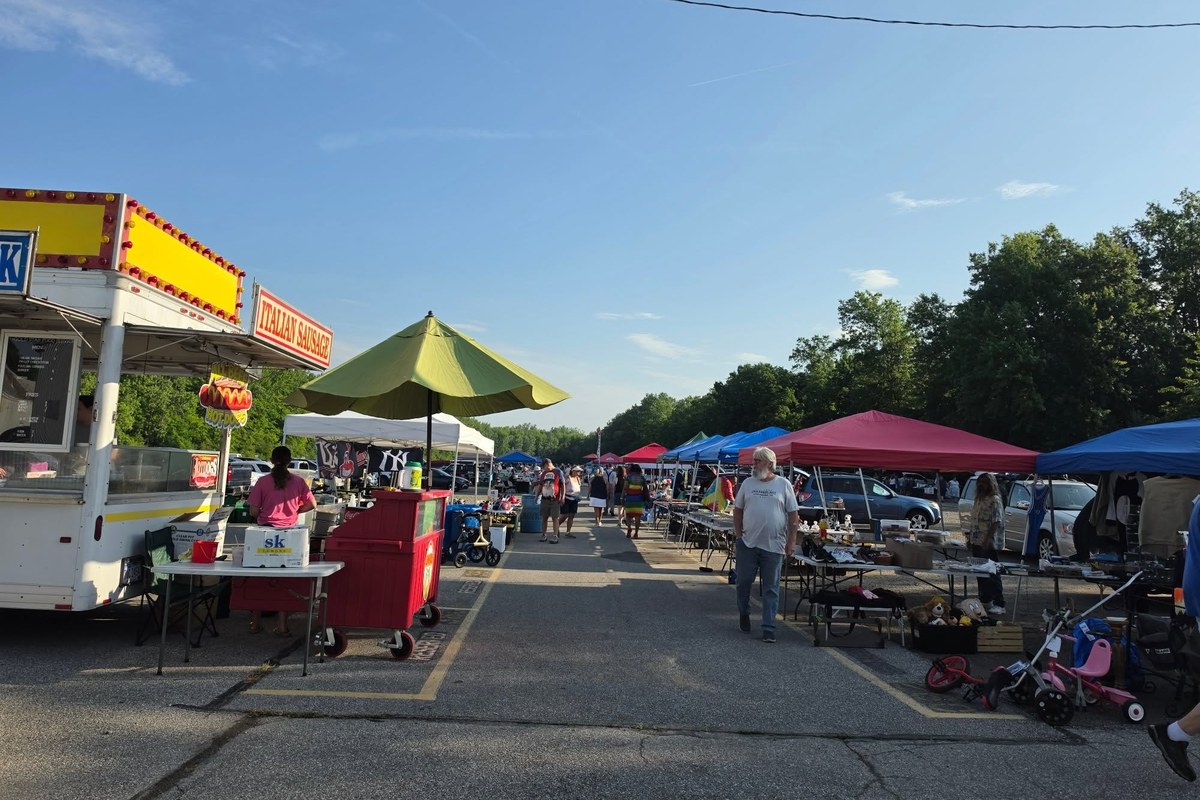 Shoppers walking the outdoor vendor rows at Jamie's Flea Market in Elyria