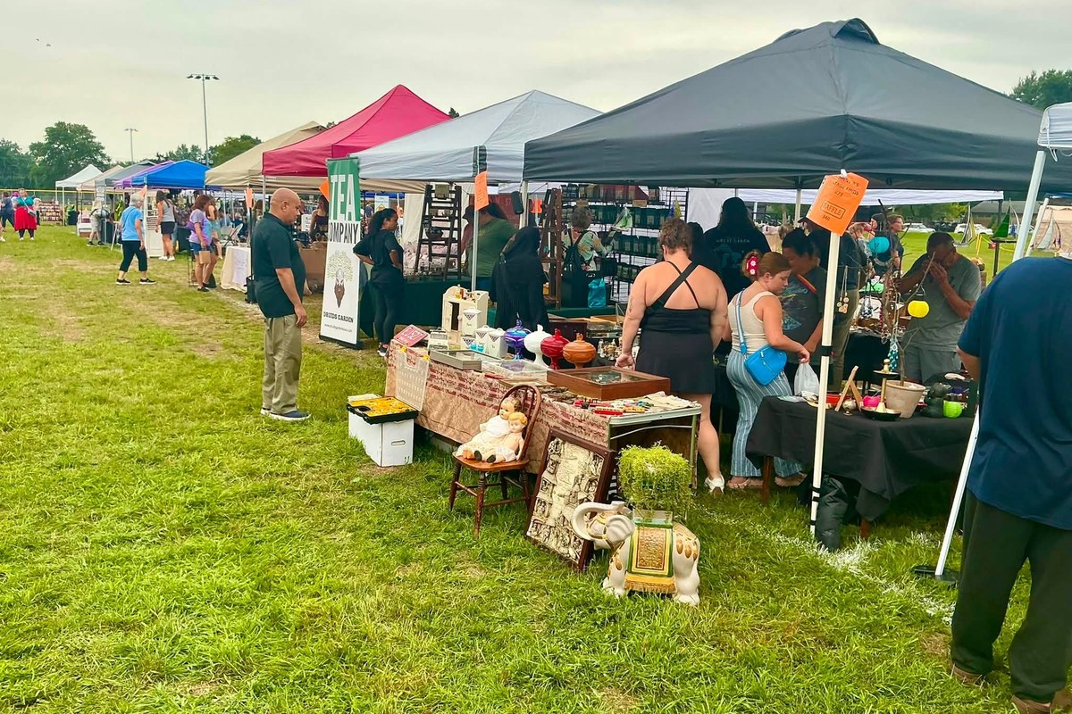 Shoppers browsing vendor tents at the Westside Flea in North Olmsted Community Park in North Olmsted