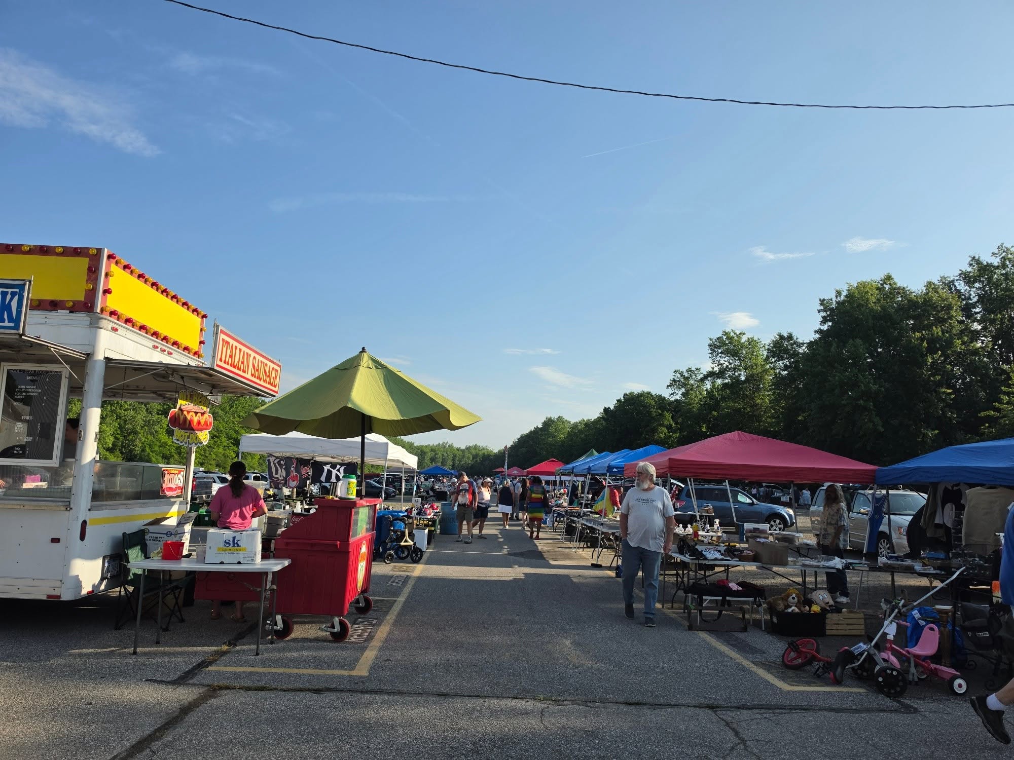 Shoppers walking the outdoor vendor rows at Jamie's Flea Market in Elyria