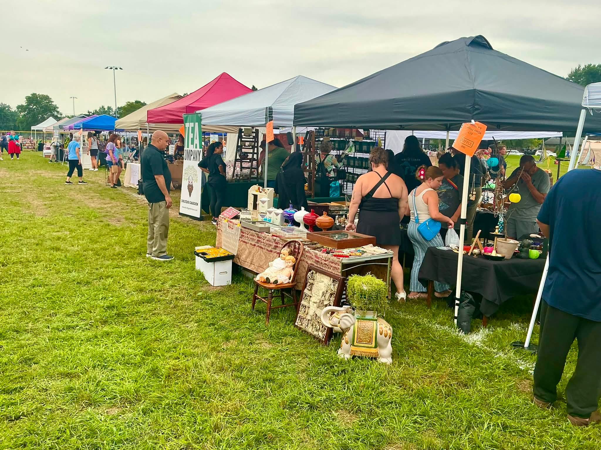 Shoppers browsing vendor tents at the Westside Flea in North Olmsted Community Park in North Olmsted
