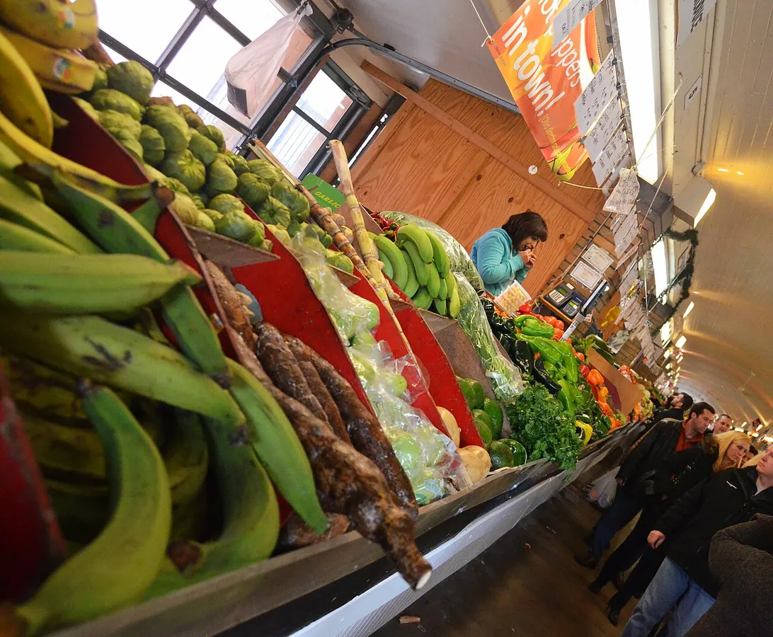 Produce stalls in the West Side Market arcade; the pictured stand is not identified as Vegetable Produce